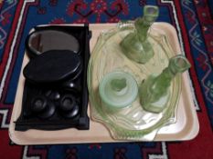 A tray of early twentieth century green glass dressing table set,