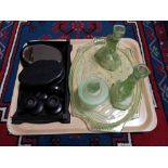 A tray of early twentieth century green glass dressing table set,
