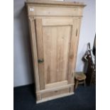 A pine single door cabinet fitted with a drawer