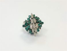 An 18ct gold emerald and diamond cluster ring,