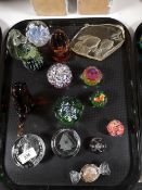 A tray of glass paperweights,