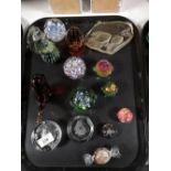 A tray of glass paperweights,