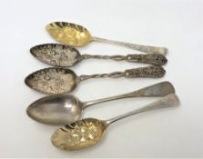 Two Georgian silver gilt repousse berry spoons,