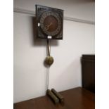 A mid century continental wall clock with pendulum and two weights