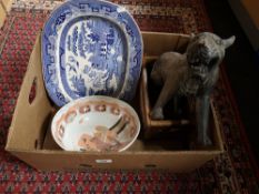 A nineteenth century blue and white meat plate, decorative tiger figure, wooden bottle rack,