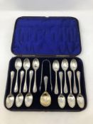 A Victorian cased set of twelve silver spoons, tongs and matching caddy spoon.