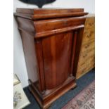 A nineteenth century pine pedestal cabinet fitted with a drawer