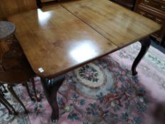 A reproduction early twentieth century extending dining table