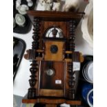 An Edwardian stained beech wood wall clock