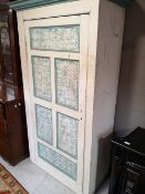 A rustic painted pine cabinet