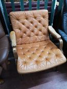 A Scandinavian studded leather armchair.