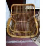 A mid century wicker armchair.