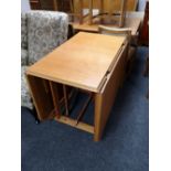 A mid century beech flap sided table