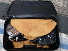 A suitcase containing leather jackets and bags etc
