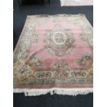 A Chinese pink fringed carpet,