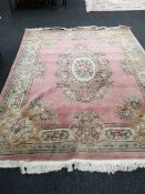 A Chinese pink fringed carpet,