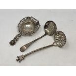 Three silver strainers