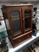 A reproduction mahogany jewellery cabinet with Asprey advertising decoration