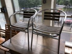 A pair of aluminium and wood slatted patio chairs.