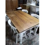 A rustic pine farmhouse table and four painted chairs