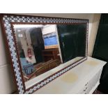 A Scandinavian mirror with tiled surround.