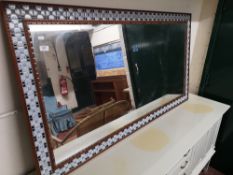 A Scandinavian mirror with tiled surround.