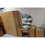 A mid 20th century maple three piece bedroom suite comprising of double wardrobe,