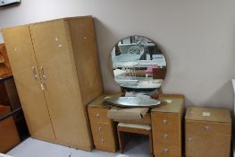 A mid 20th century maple three piece bedroom suite comprising of double wardrobe,