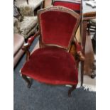 A reproduction armchair in red dralon