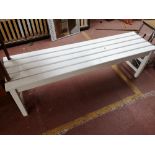 A painted pine wooden slatted bench.