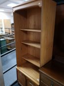 A teak effect bookcase fitted with cupboards