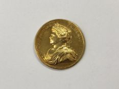 A Queen Anne yellow metal medallion 1713,