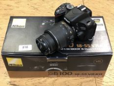 A Nikon D5100 digital camera with DX AF-S Nikkor 18-55mm lens,