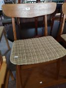 A set of mid century teak dining room chairs.