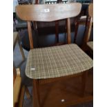 A set of mid century teak dining room chairs.