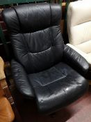 A blue leather relaxer chair.