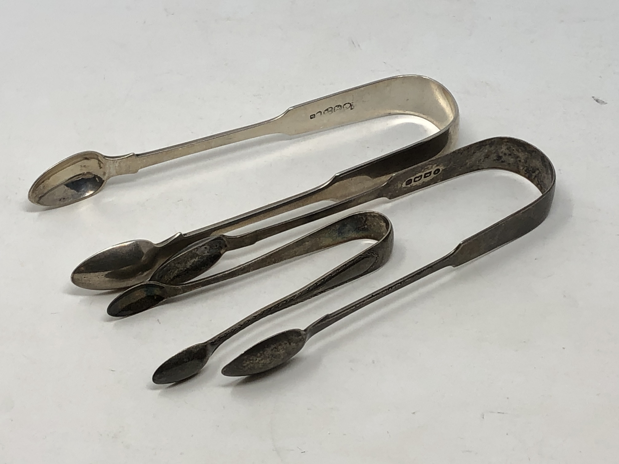 Three pairs of silver sugar tongs including a Newcastle silver pair (3) CONDITION REPORT: