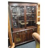 A mahogany double door bookcase fitted with three cupboards