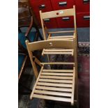 A set of four folding beech chairs