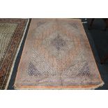 A fringed eastern rug on peach ground,