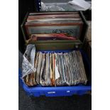 A box of vinyl singles and lps