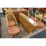 An Ercol elm flap sided table and four chairs