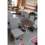 A contemporary extending dining table and six cloth covered chairs