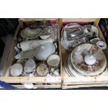 Two crates of china plates, cutlery, gilded tea china,