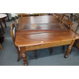 A Victorian mahogany extending dining table with leaf and four dining chairs,