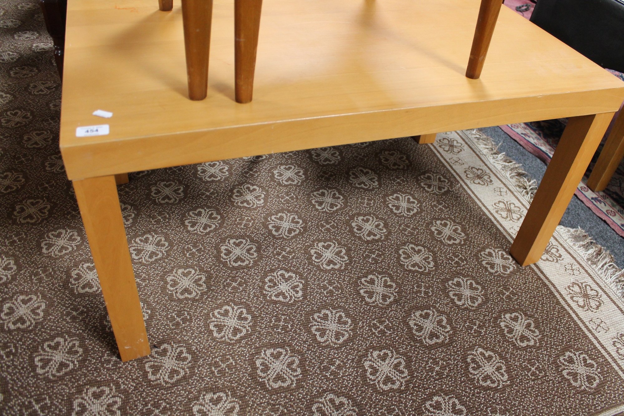 A beech coffee table together with a pair of leather chairs