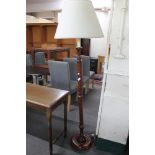 A contemporary mahogany standard lamp with shade