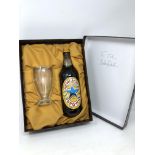 A bottle of Newcastle Brown Ale with glass in presentation box,