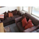A brown suede three seater settee with scatter cushions together with the matching armchair