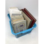 A basket of a large quantity of cigarette cards in albums,